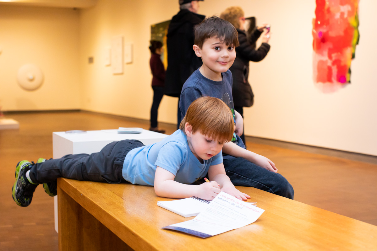 Kids on a bench enjoying and exploring the galleries