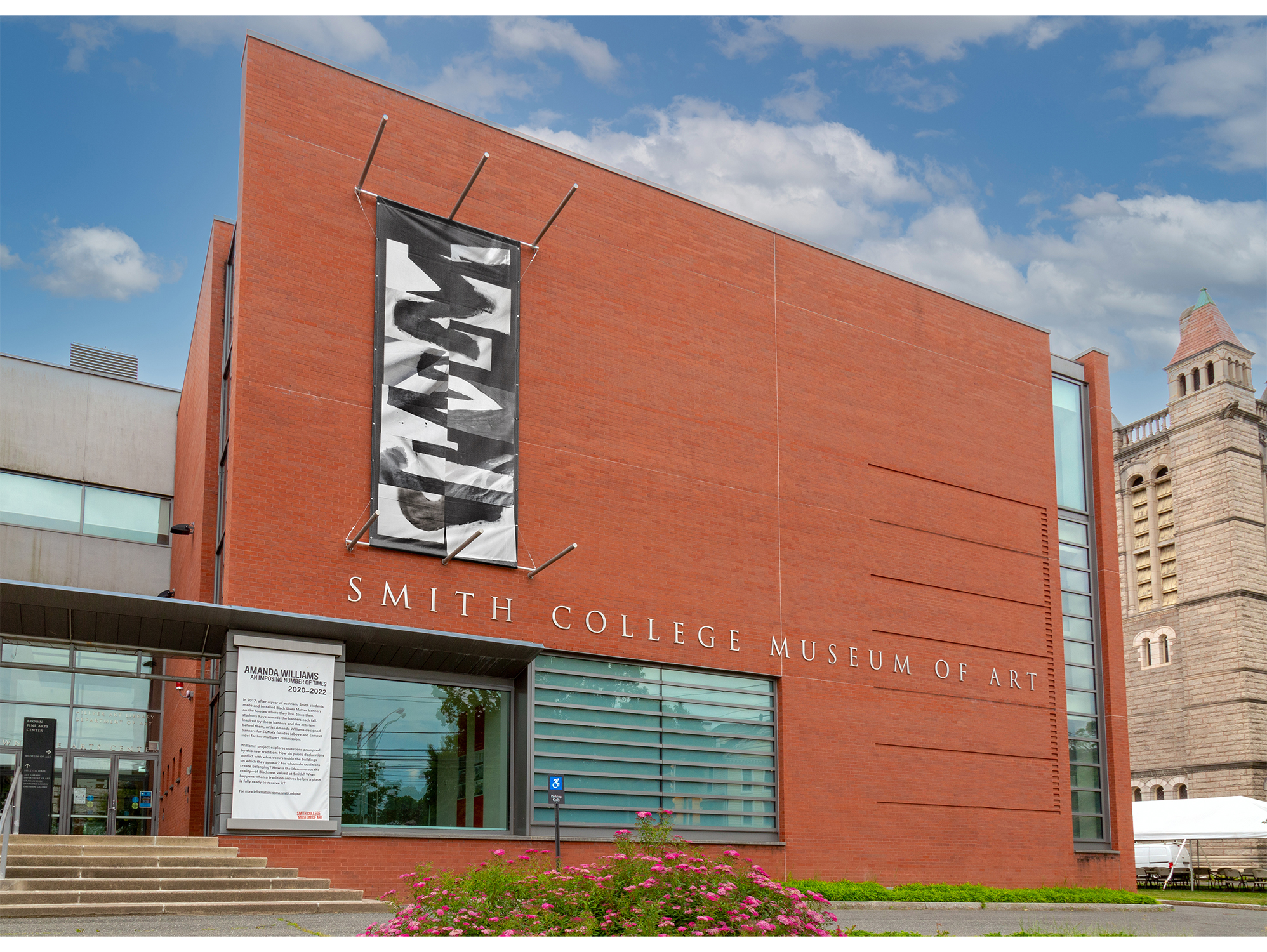 Amanda Williams, "An Imposing Number of Times" (2020–22), black and white banner on front of the Smith College Museum of Art