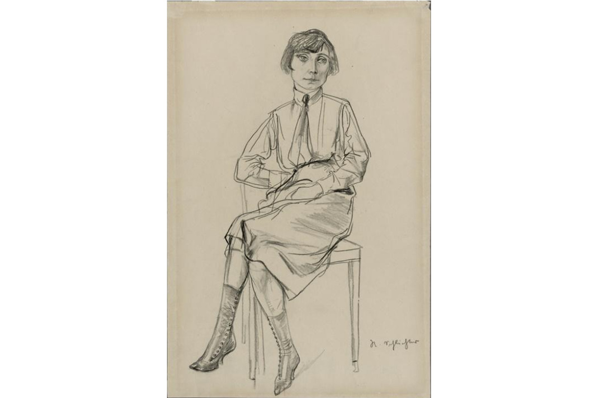 "dark haired woman wearing a necktie, shirt, and buttoned boots seated in a chair with her legs crossed"
