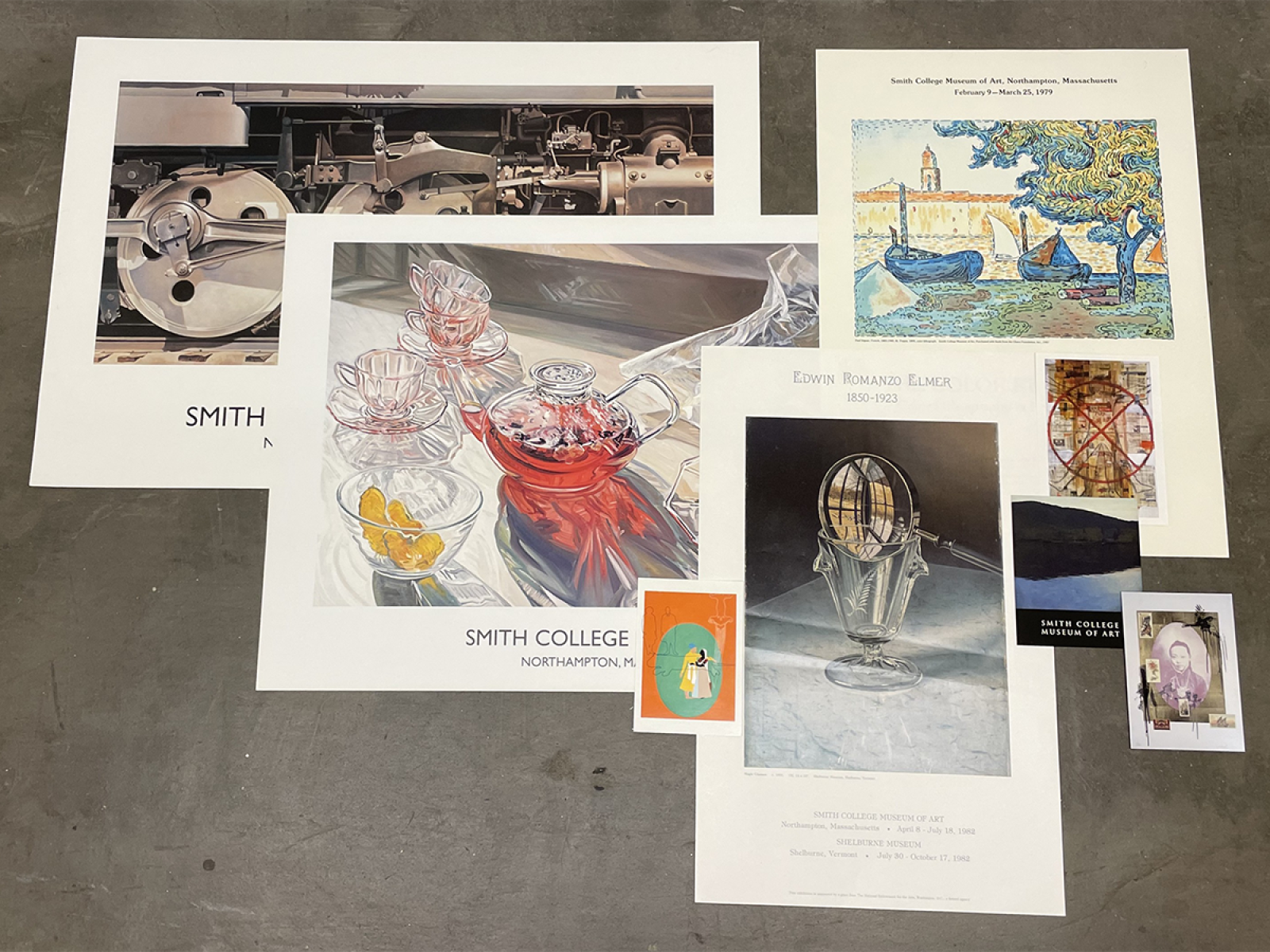 Arrangement of various posters and postcards with featured art from the museum.