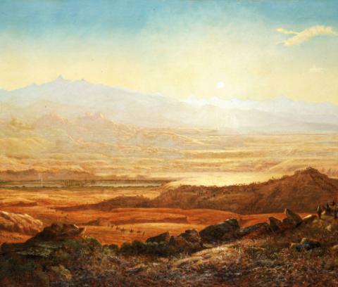 Desert mountain landscape; foreground of browns; midground of oranges, golds, and yellows; mountain horizon of golds, yellows, and blues. The sky is nearly cloudless.Groups of people – the size of ants – can be found in the valleys and mountainsides of the landscape.