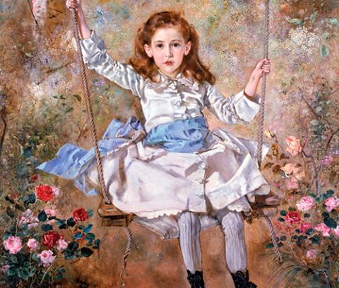 young girl in white dress sitting on a swing surrounded by flowers