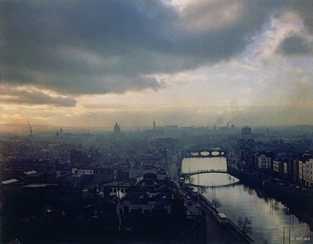 Cityscape, a river in the lower right hand corner, half sky, half city