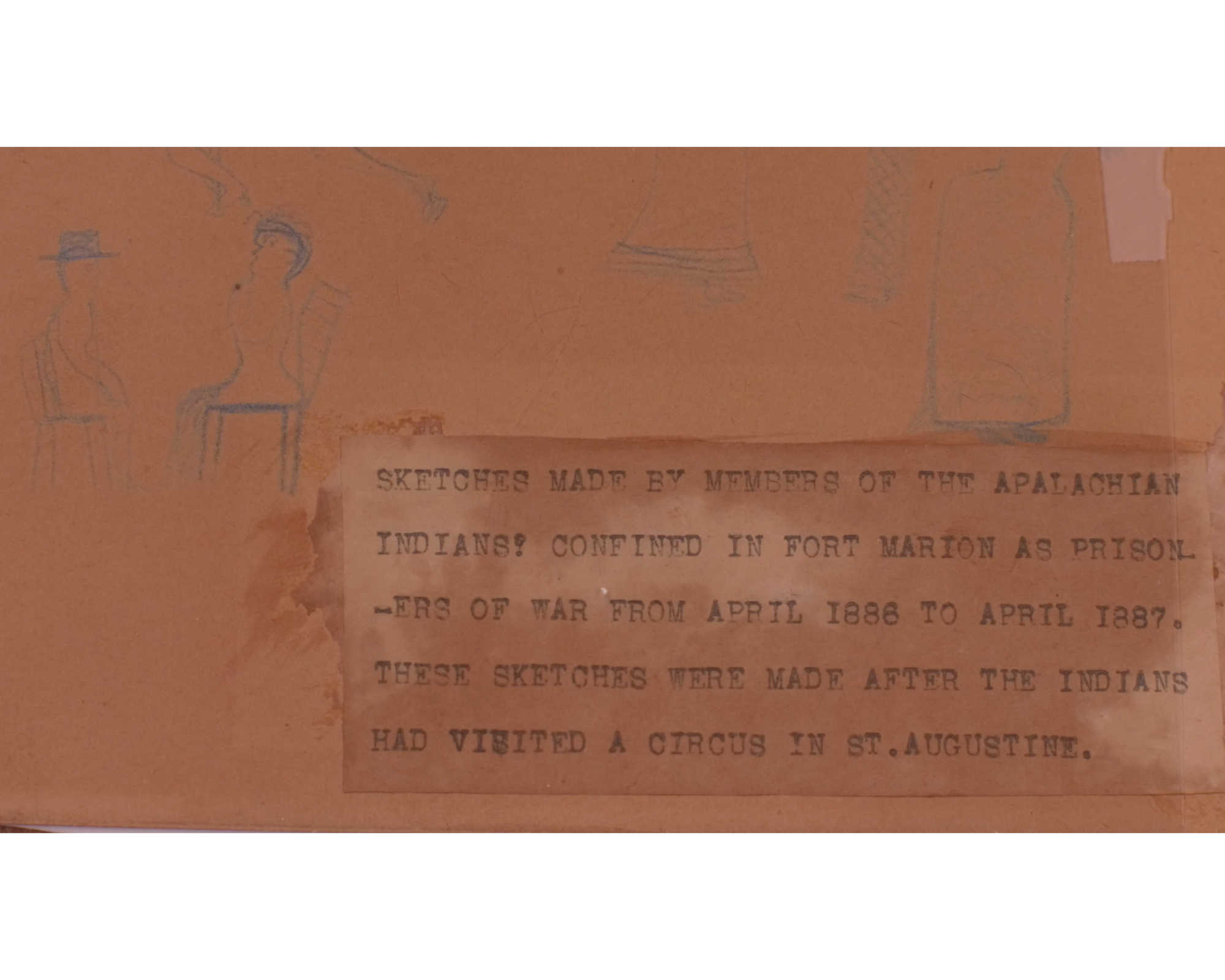 Brown paper with sketch of two people seated at a table on the left with type-written text on right reading: "SKETCHED MADE BY MEMBERS OF THE APALACHIAN [sic] INDIANS CONFINED IN FORT MARION AS PRISONERS OF WAR FROM APRIL 1886 TO APRIL 1887. THESE SKETCHES WERE MADE AFTER THE INDIANS HAD VISITED A CIRCUS IN ST. AUGUSTINE."