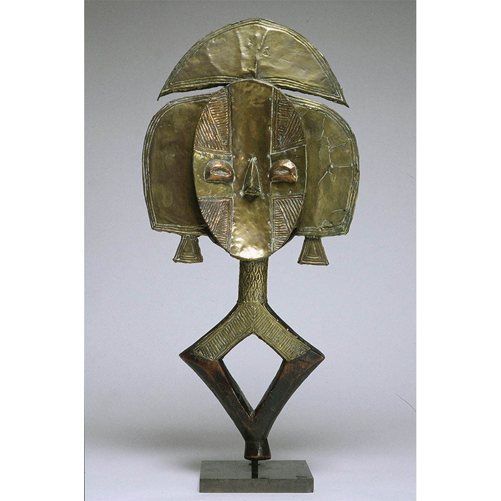 Brass sculpture of an abstract reliquary figure. 