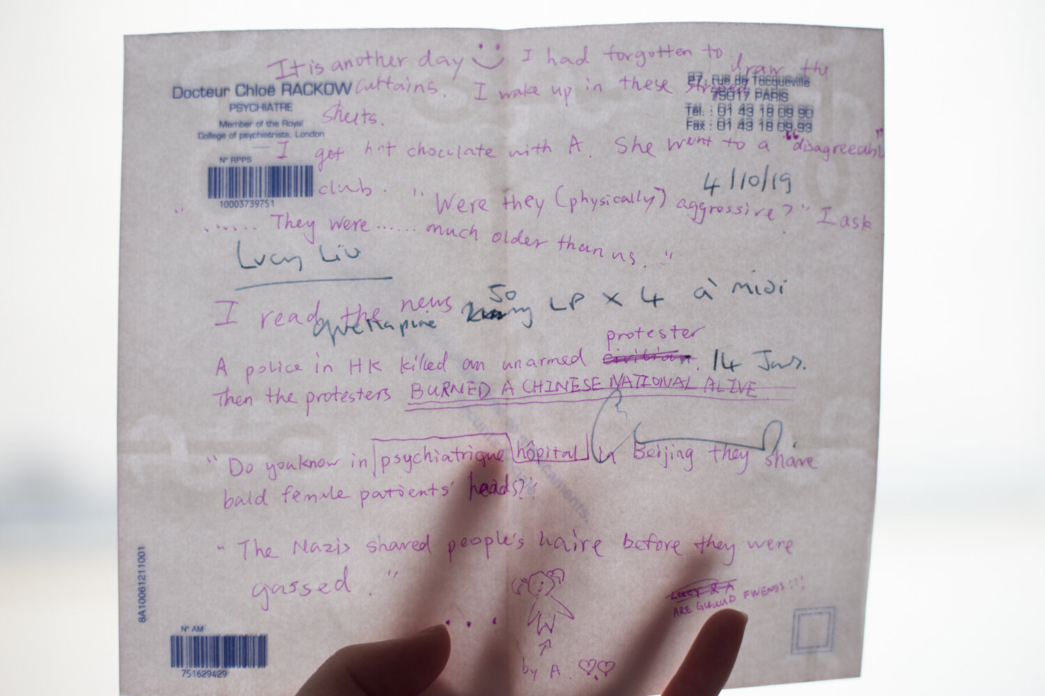 Photograph of a translucent piece of paper held up to the camera covered in notes in pink and black pen in English and French, including the artist’s name. Two barcodes and the name, address, phone, and fax numbers are printed in top left and right corners.