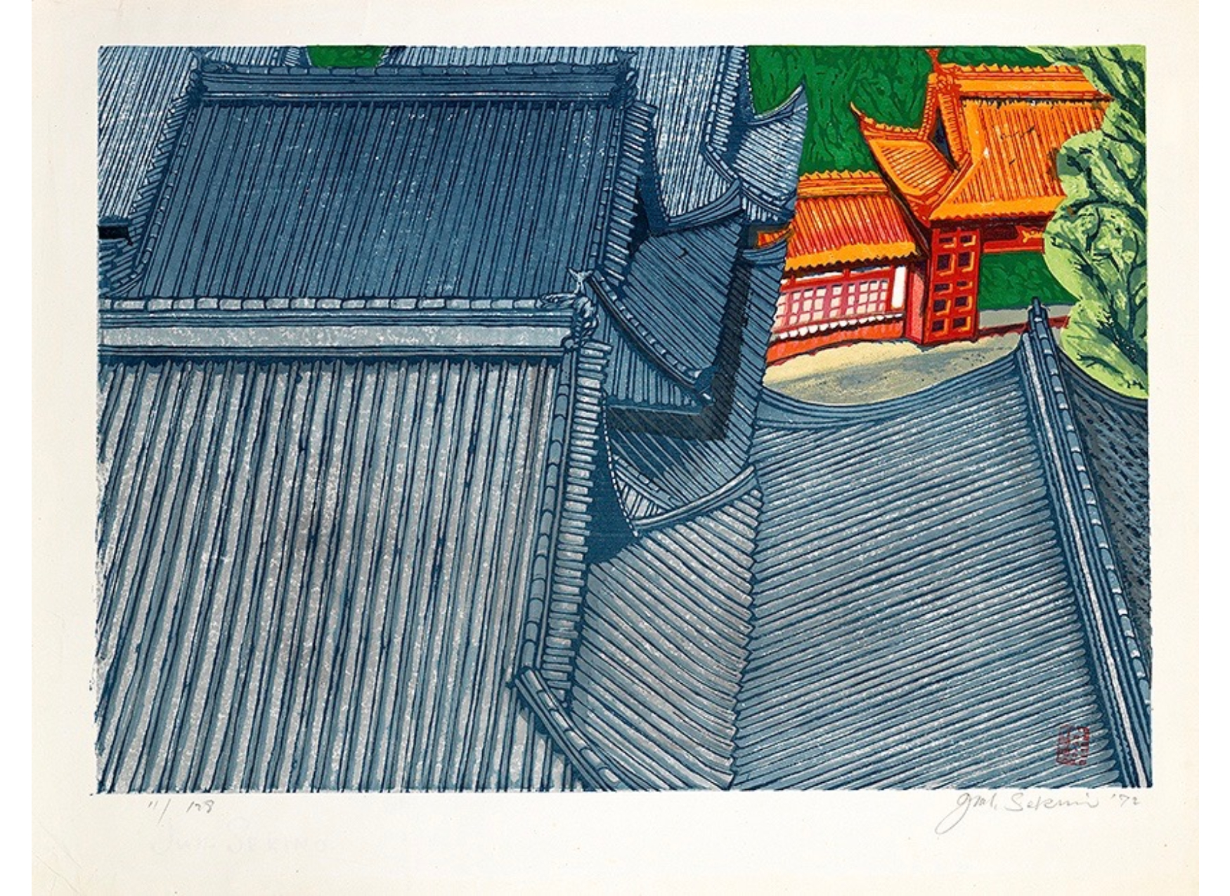 Blue rooftops in foreground of image, red temple in upper proper left, green background.