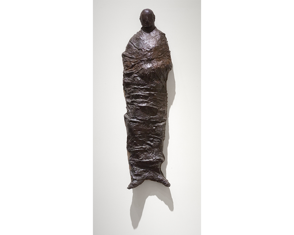 hanging sculpture of a shrouded figure