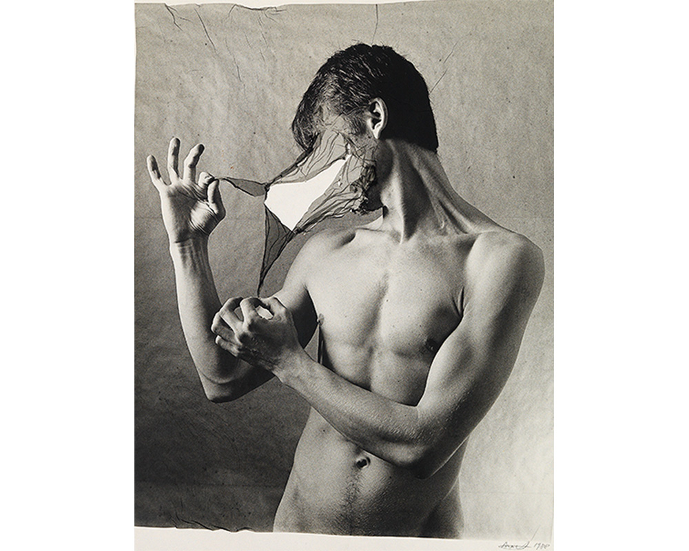 black and white portrait of male nude; 3/4 of torso visible; peeling away layer of face