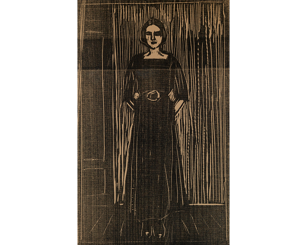 woman with straight dark hair tied behind head, parted at center, wearing dark square necked dress with beld standing with hands behind back and feet together on wood floor near wall wiht door visible at her proper right