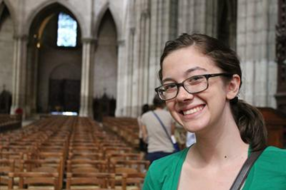Image of Colleen smiling in the Cathedral of Saint Denis.