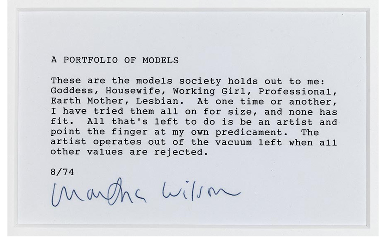 white piece of paper, with black typewriter text that reads: "A PORTFOLIO OF MODELS.  These are the models society holds out to me: Goddess, Housewife, Working Girl, Professional, Earth Mother, Lesbian. At one time or another, I have tried them all on for size, and none has fit. All that's left to do is be an artist and point the finger at my own predicament. The artist operates out of the vacuum left when all other values are rejected.  8/74"