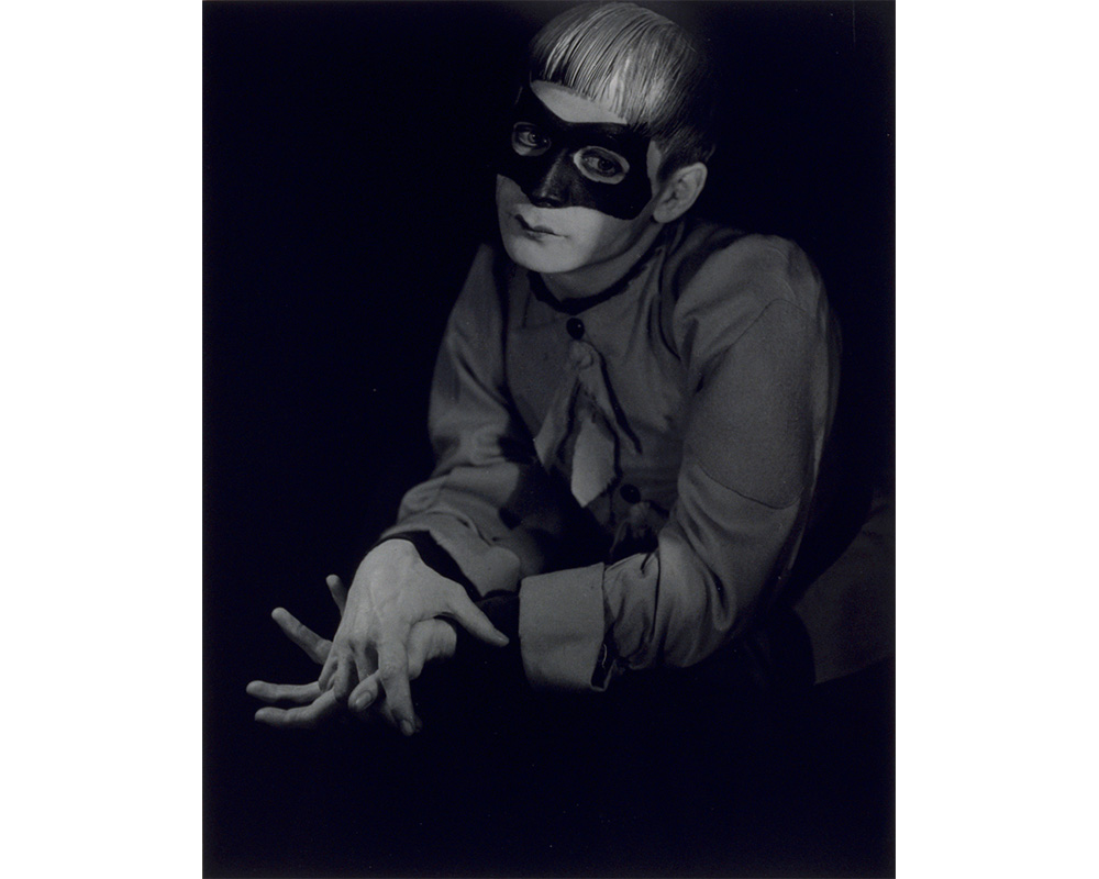 portrait of white man wearing dark clothes and a mask