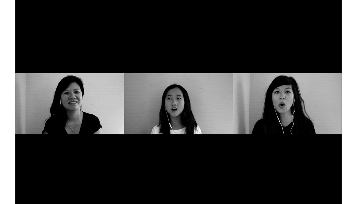 three side-by-side screens appear with two sisters in black shirts, the artist on the right, her sister on the left, with the artist's young niece in a white shirt in the center, wearing white headphones against a light background; all three have long dark hair