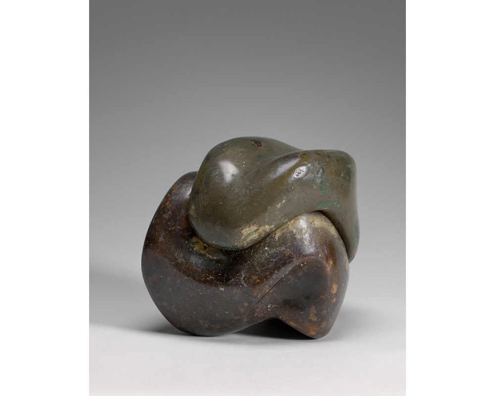 sculpture in two undulating parts that fit together in a cube-like shape; smooth yet textured surface; one half is more green in tone, other half is a richer brown