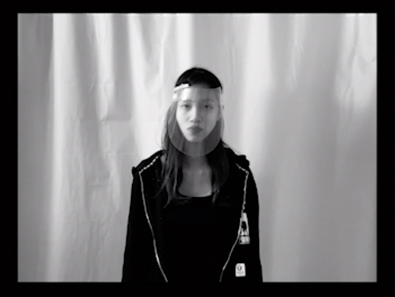 Screenshot of student wearing a face shield in black and white.