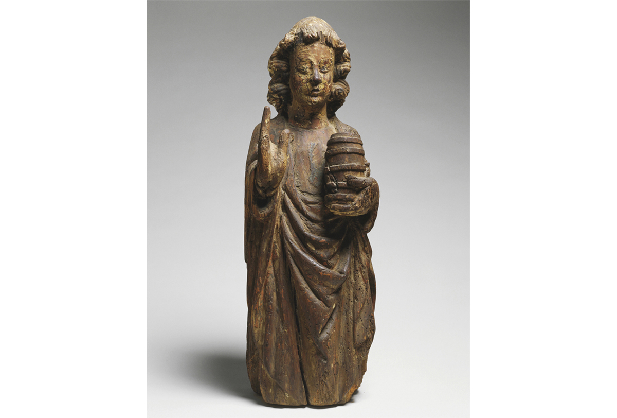 carved wooden figure standing with left hand raised, right hand holding small cask of beer