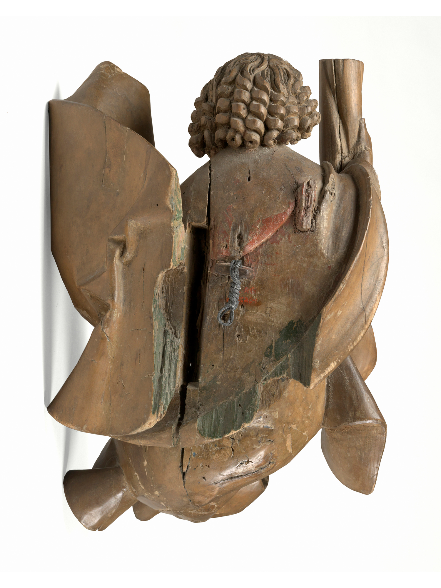 Back of the wooden sculpture of angel bearing a column
