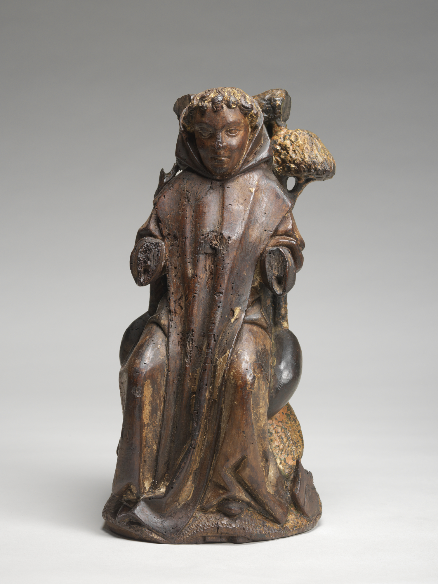 Image of wooden sculpture of a seated figure