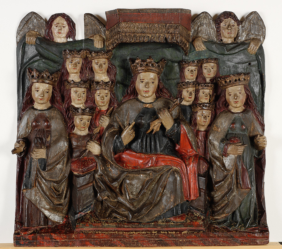 Painted wood sculpture of woman with crown surrounded by other women with crowns who look like her, with two angels in background
