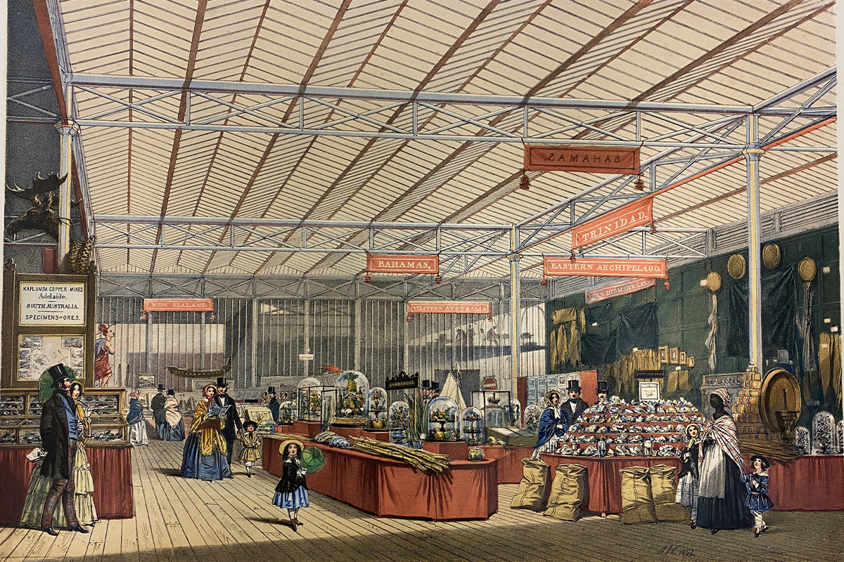 Large room with tables displaying different products from around the world, including coffee/tea and fruit. Several European people, and one woman of African descent,  walk around the room
