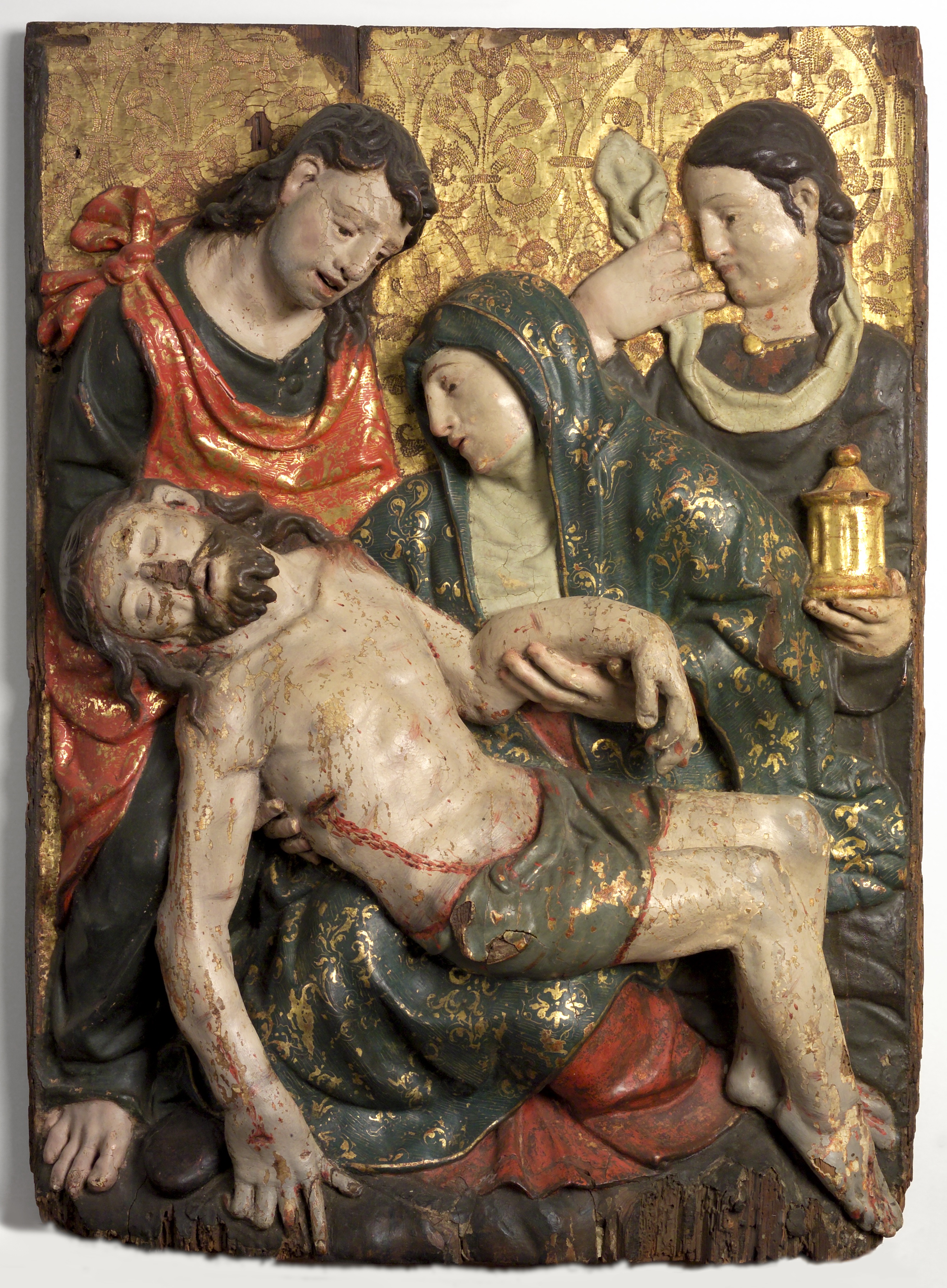 Carved and painted wood sculpture showing Mary holding her dying son's body.