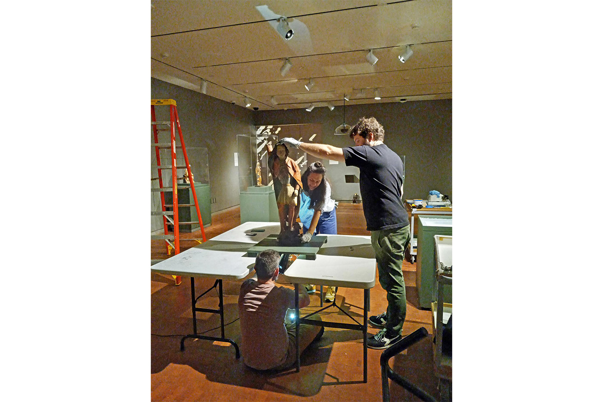 Nik, Leah and Matt secure the mount for St. Michael on the underside of the pedestal’s removable top