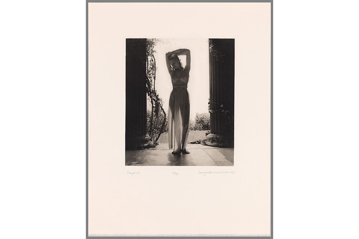 "young woman with arms above her head between two pillars; dancer; Greek; modern dance; garden; colomns; architecture"