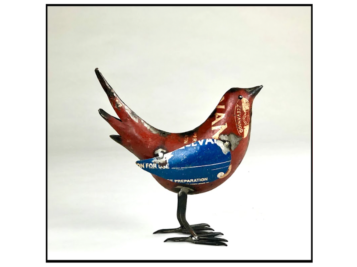 Photo of a bird made of metal in red and blue