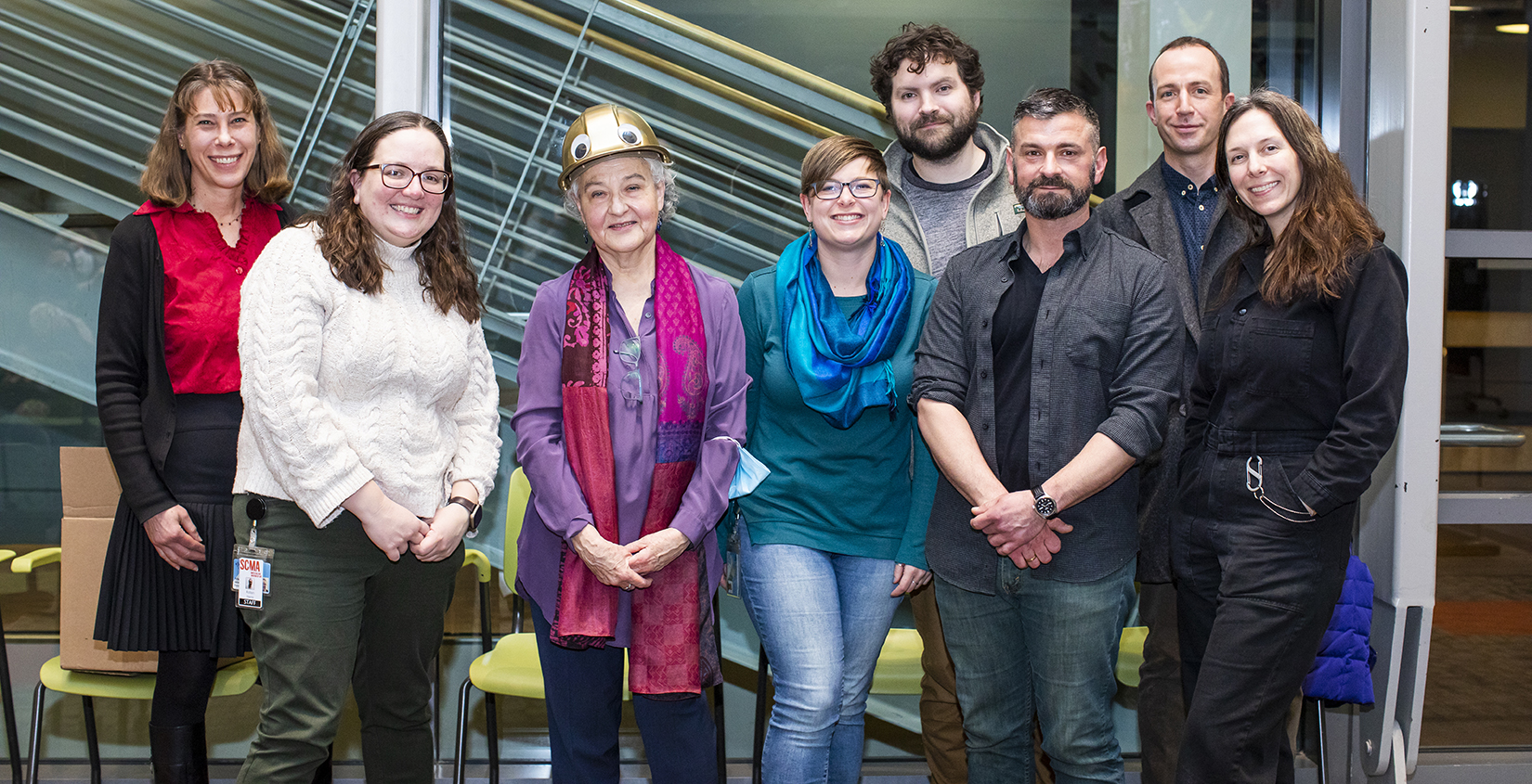 Eight people standing together for a group portrait