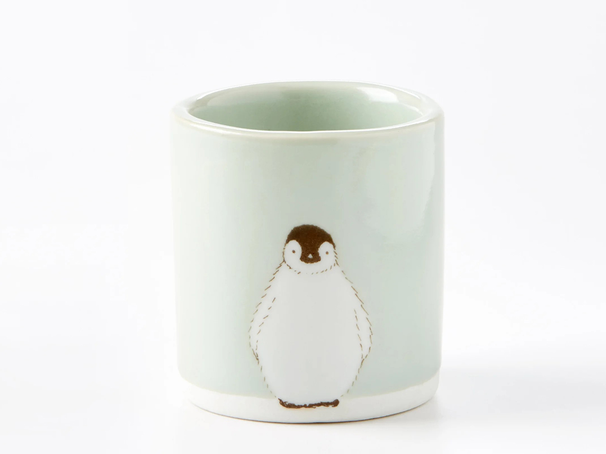 Ceramic cup with a penguin drawn on it