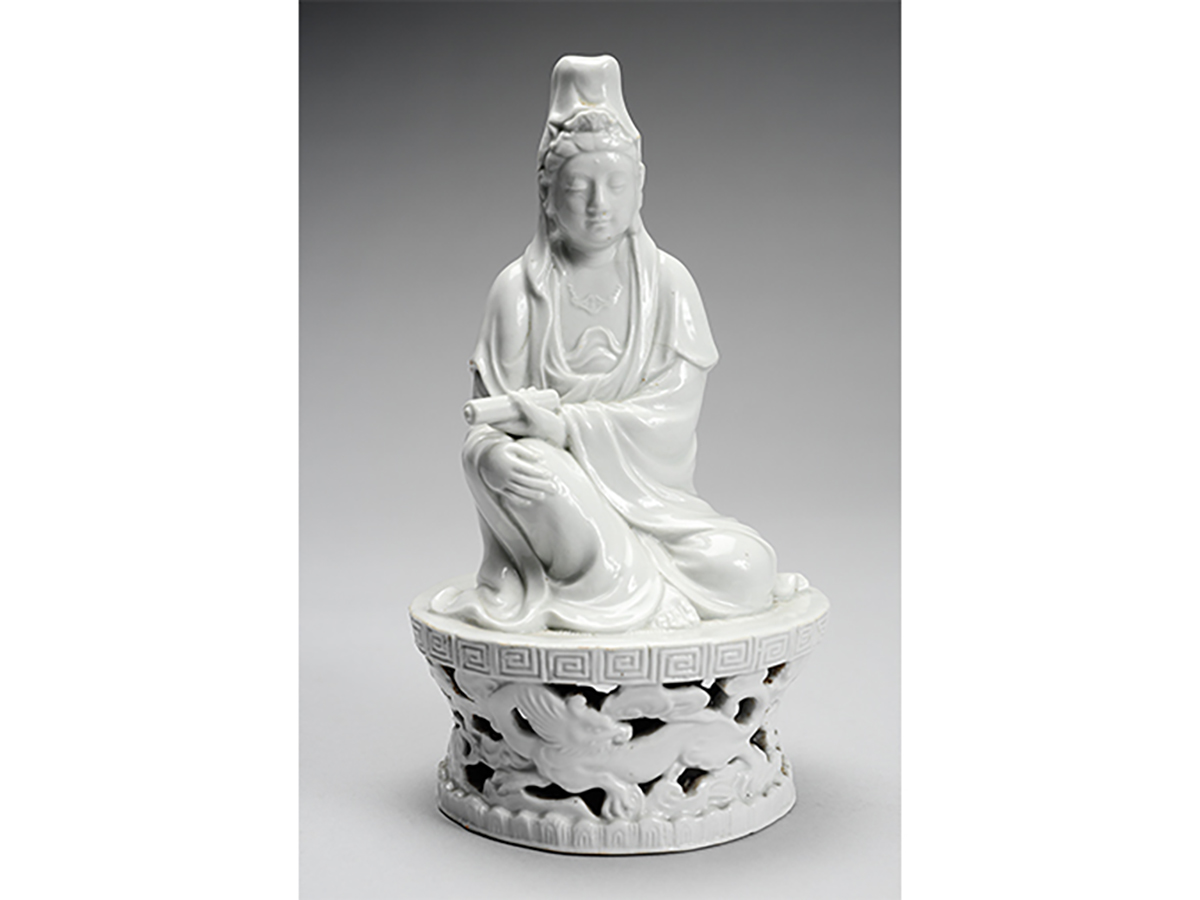 Carved white jade figure sitting cross legged