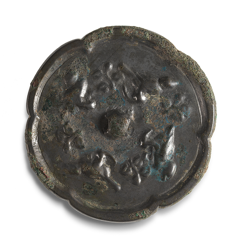 Dark bronze mirror with six wide petal lobes around the edge. A small square protrudes from the center and is surrounded in a circle by ducks in relief.