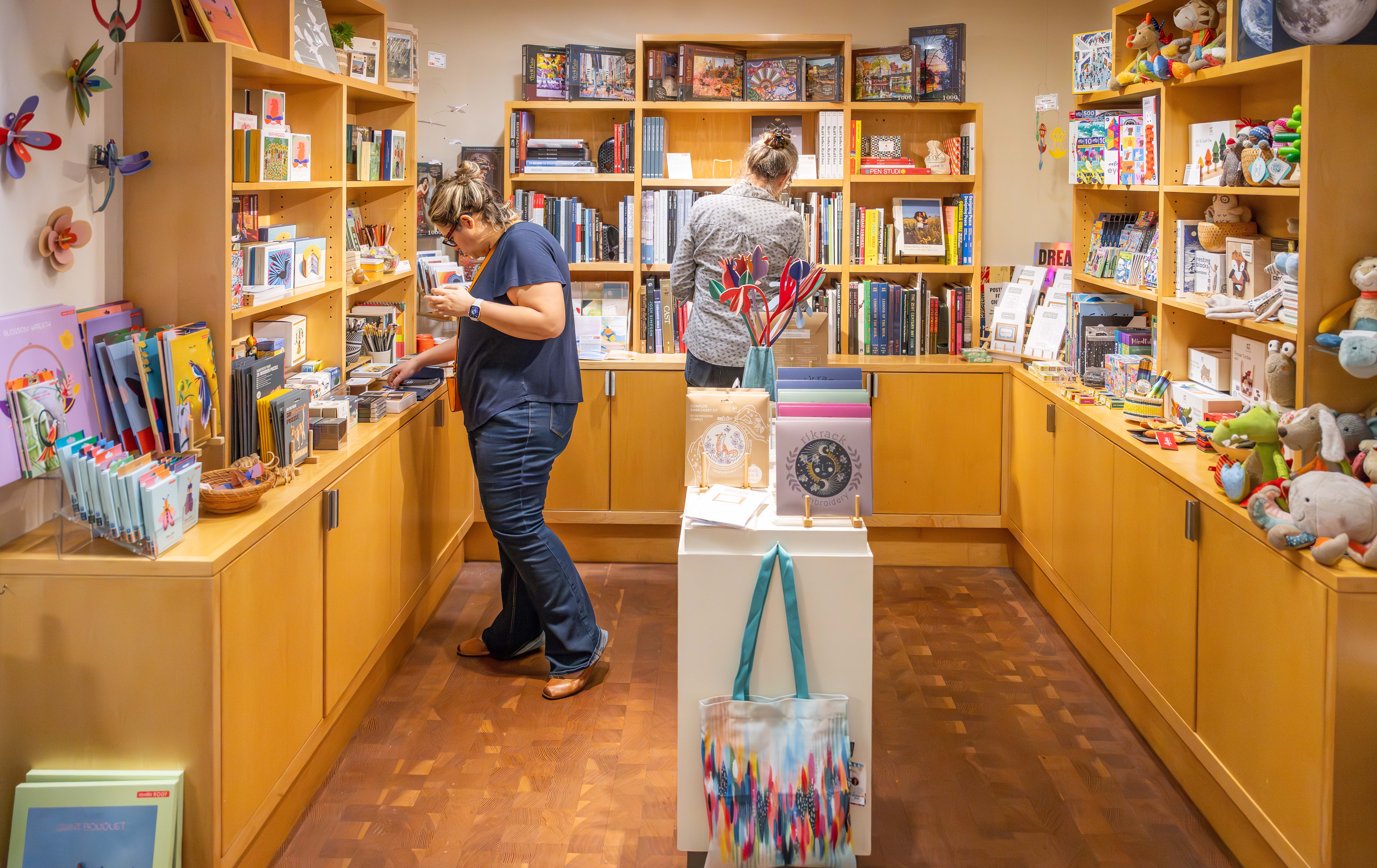 Two people browsing in the SCMA Shop