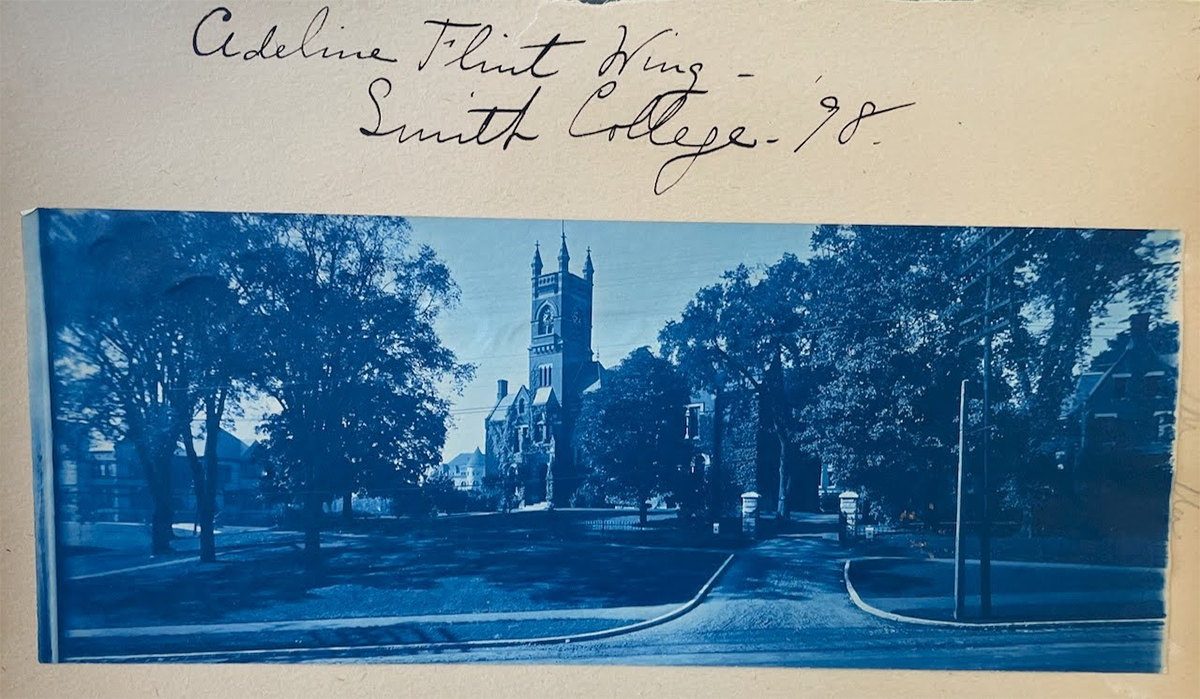 A section of a photo album including a photograph of Smith College, signed above “Adeline Flint Wing, Smith College ‘98.”