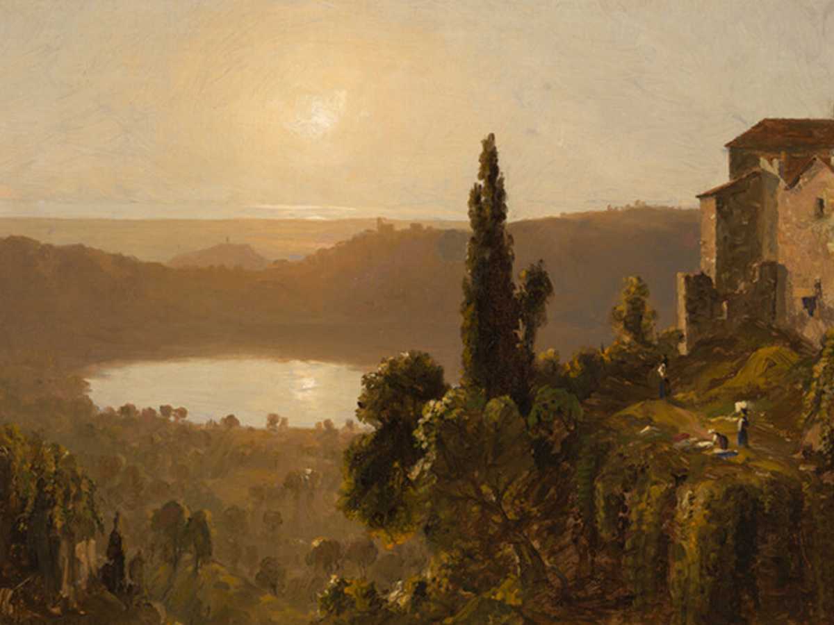 sunlit landscape looking in valley from up high at a lake 