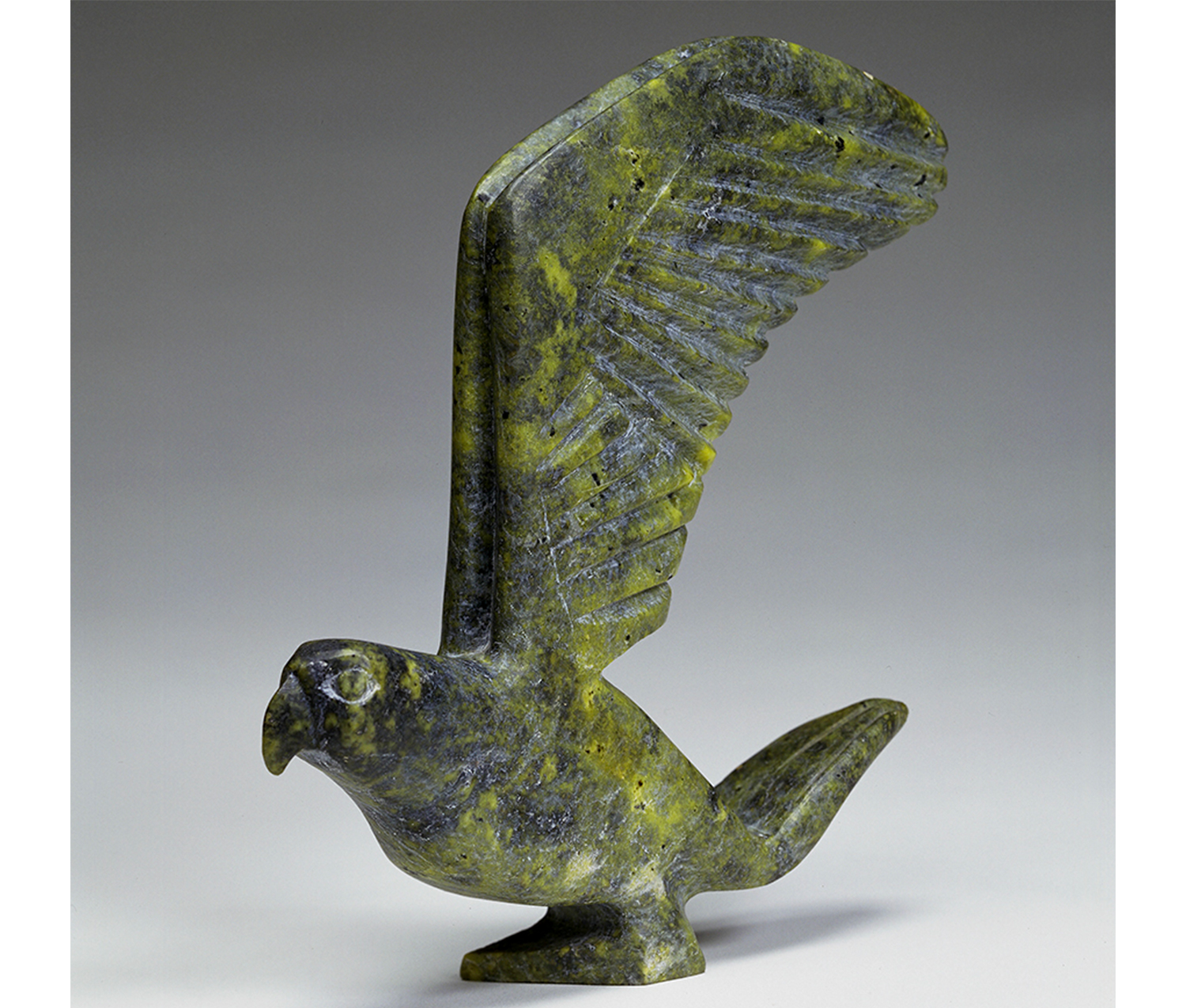 green sculpture of a bird with large wings