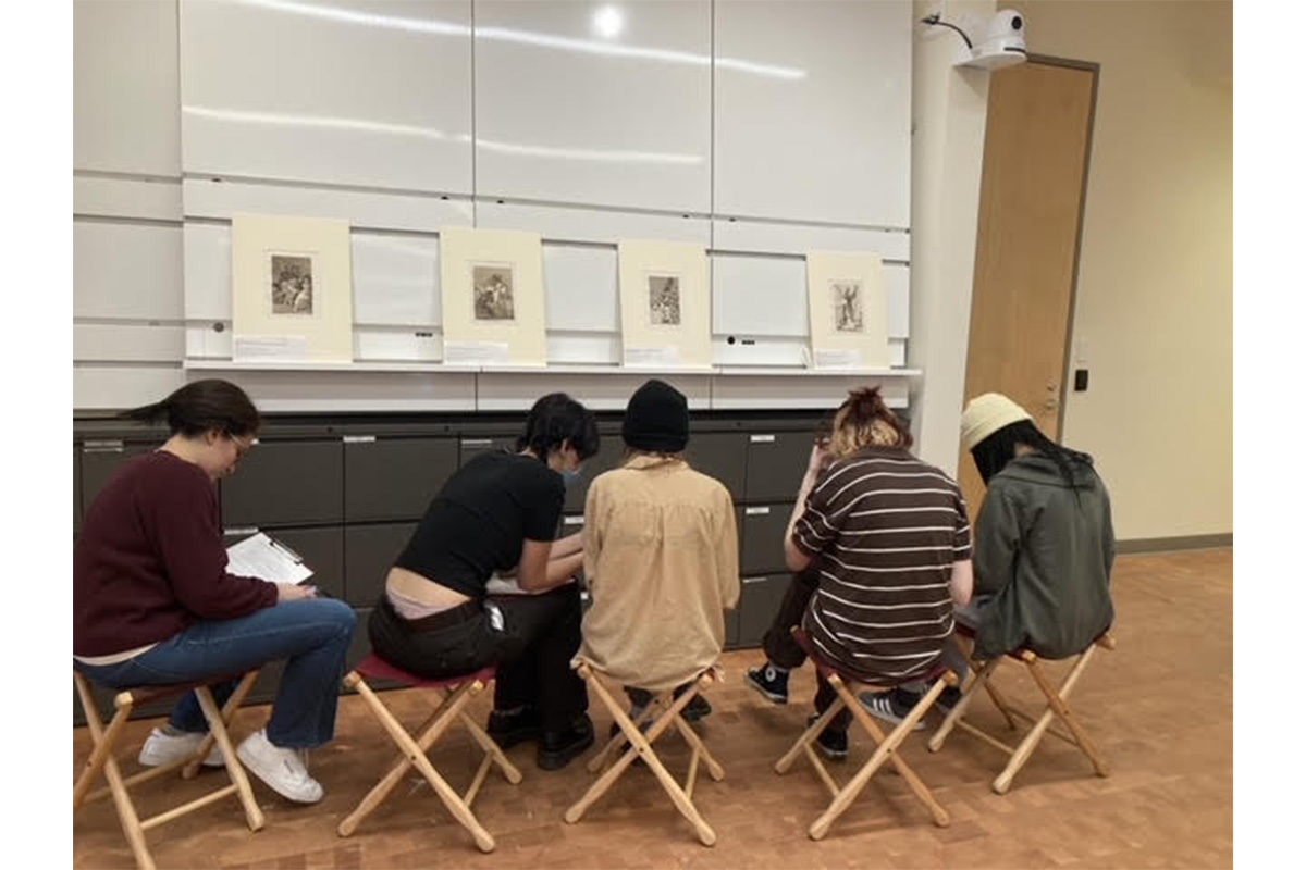 Students gathered in observation of Goya's prints