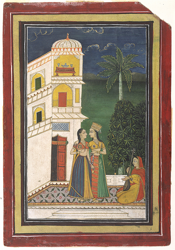 "two women on a terrace in front of a three story building standing arm in arm listening to a woman seated before them playing an instrument"