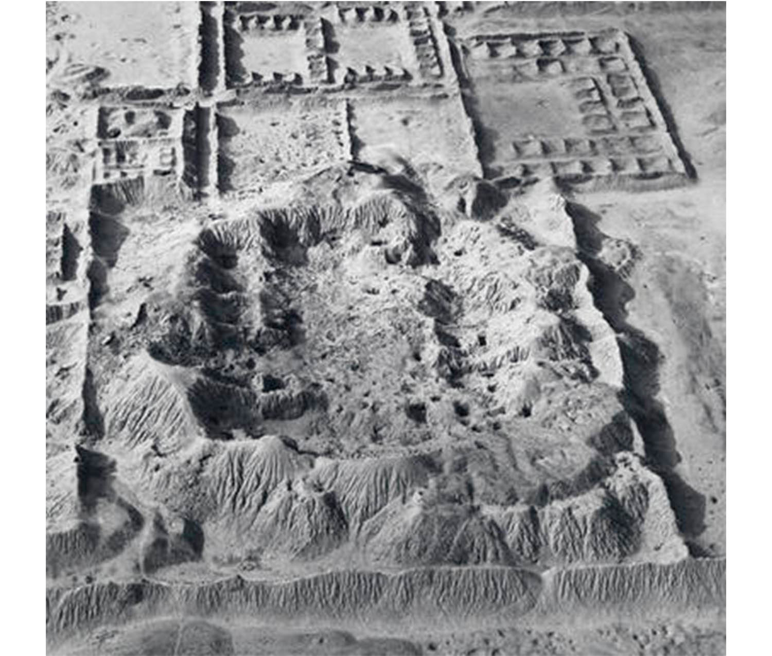close-up of aerial view of sandy area with low dirk mounds and rectangles of ruined buildings