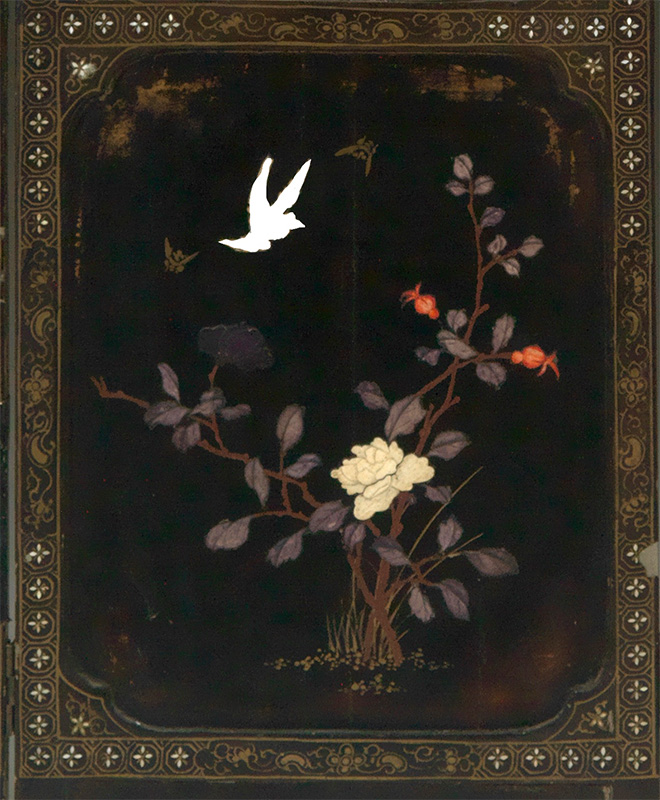 "close up of one panel of Coromandel Screen with white shape of magpie overlayed"