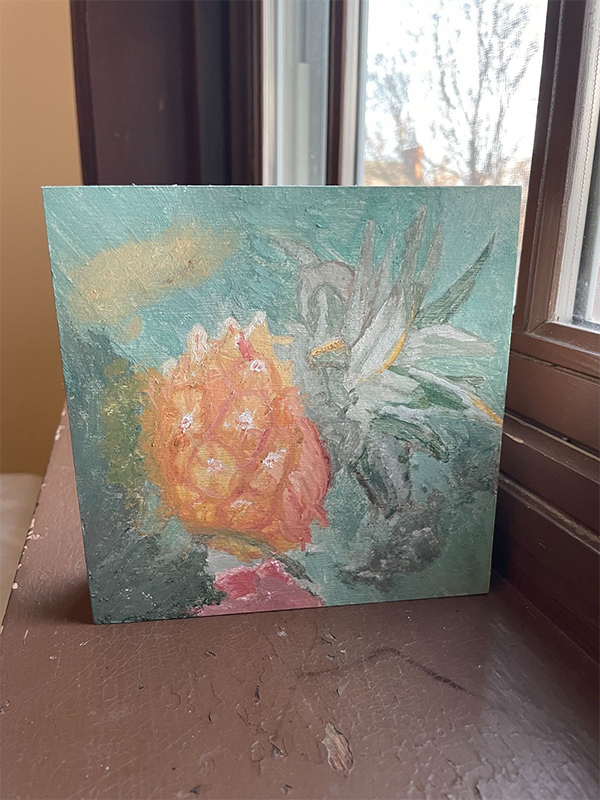 a pineapple, fish, and flowers painted in pastels on a wooden block