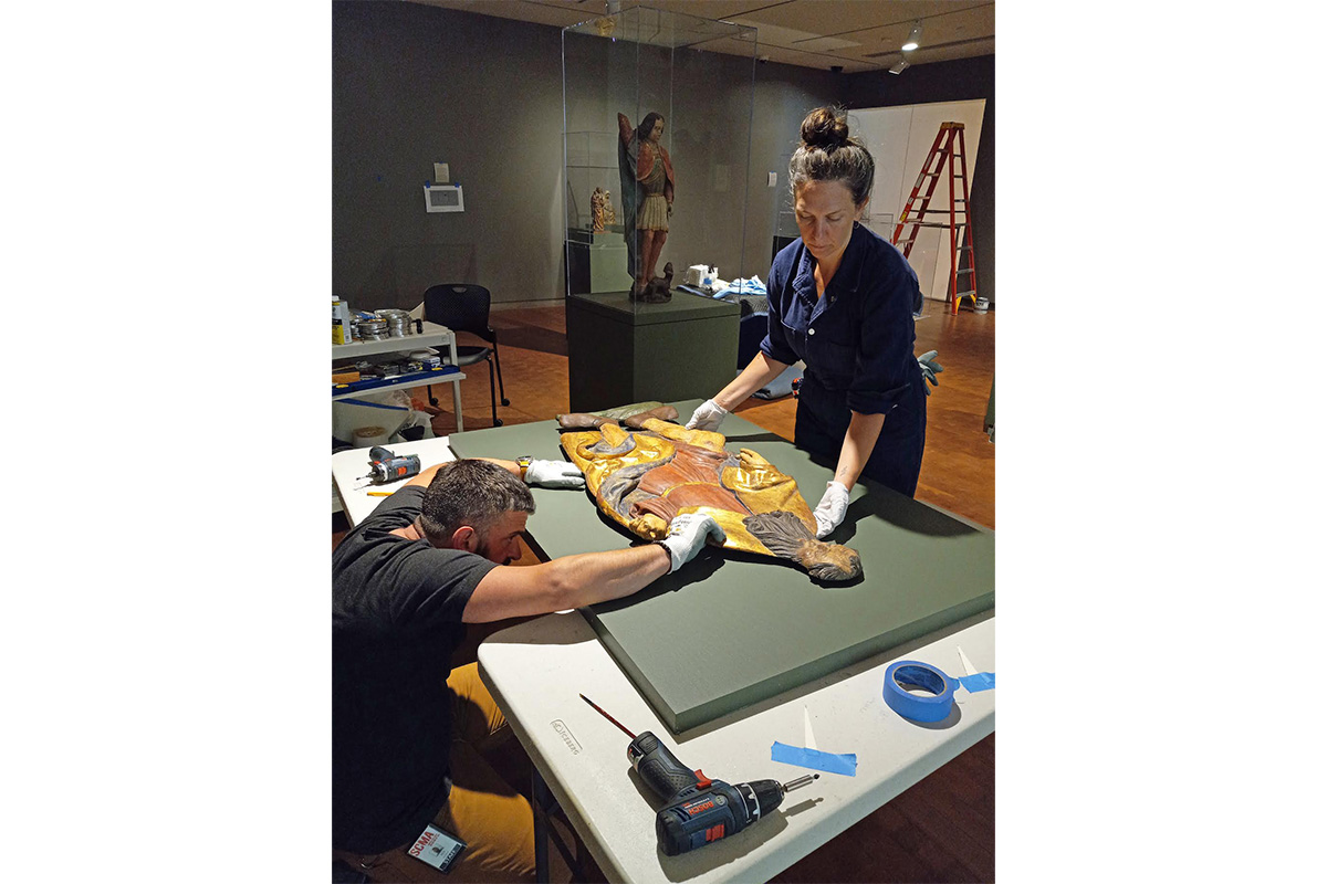 "Nik and Leah work on the placement of mounting clips for St. Roch"