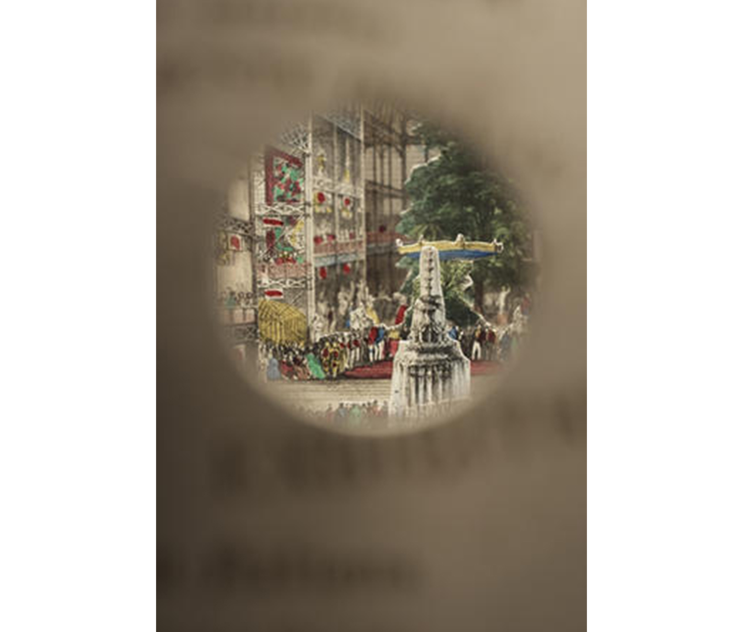 zoom-in view through a circular lens of a small, colorful print featuring a tree and the top of a building