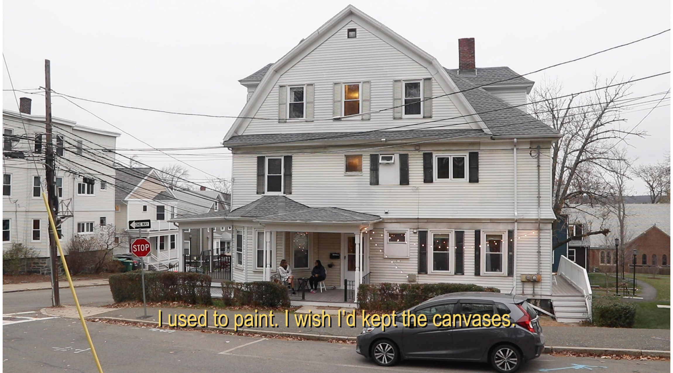 white house in neighborhood. text at bottom reads: "I used to paint. I wish I'd kept the canvases."