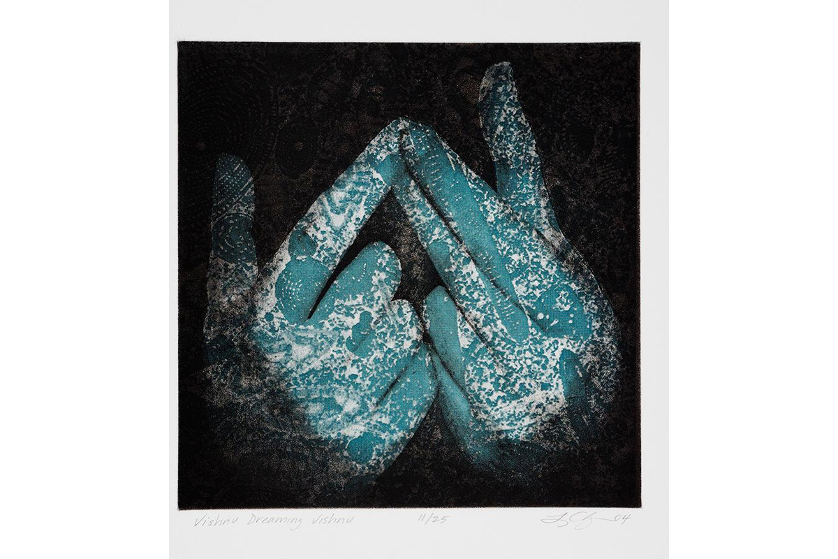 "two hands overlaid with printed cloth"