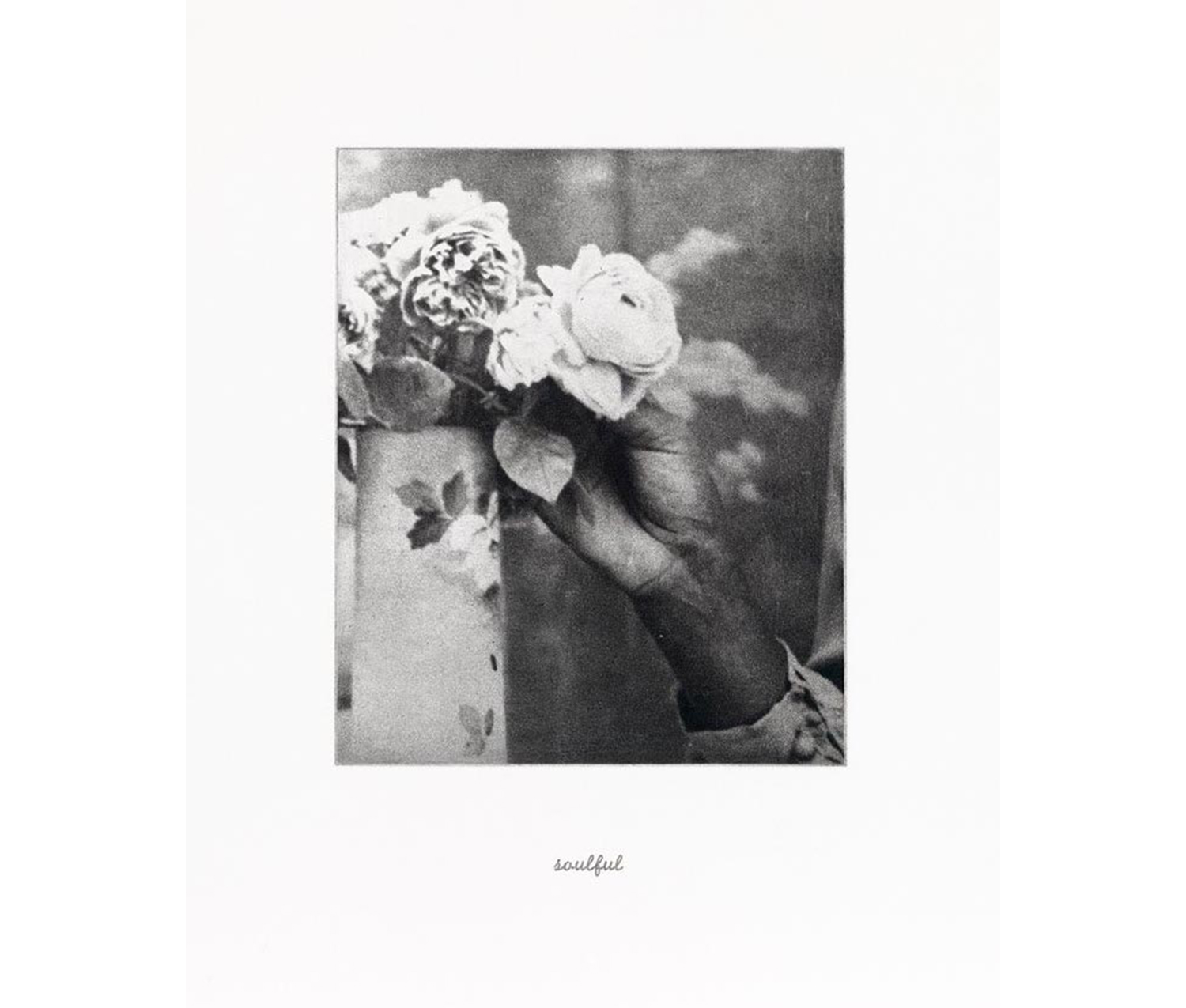 African American hand holding white flower in a vase with flower design on it; on the bottom of the image, the word "soulful" appears written in cursive