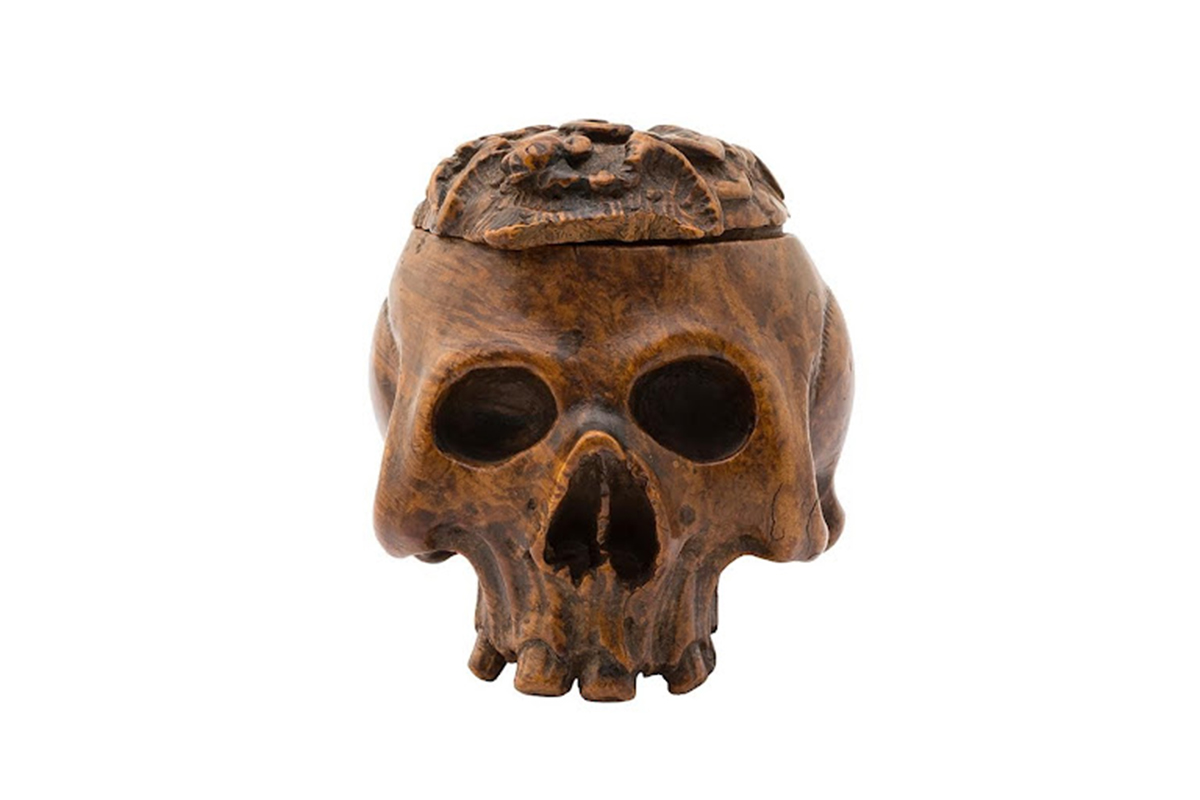 front view of skull carved from wood