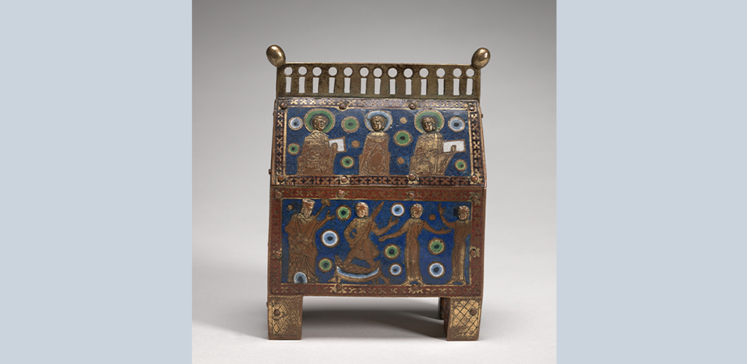 Ornate metal box in shape of a church with religious iconography inlayed on it