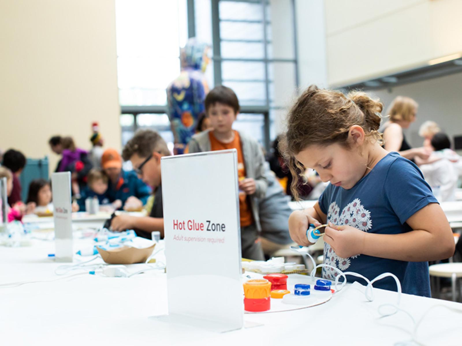 Visitors making art at the hands-on activity at Second Friday